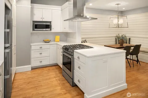 a kitchen with a stove a sink and a microwave