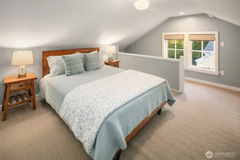 a bed sitting in a bedroom next to a window