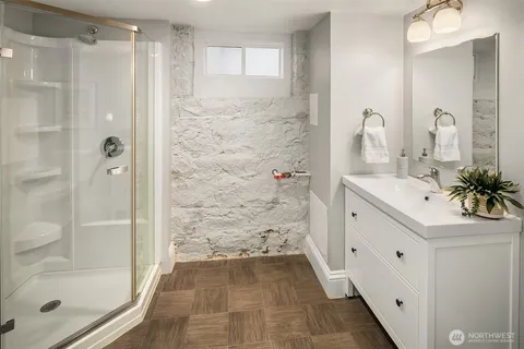 a bathroom with a shower sink and mirror