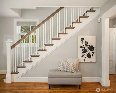 a view of entryway and hall with wooden floor