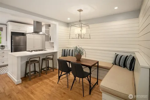 a view of a dining room with furniture and wooden floor