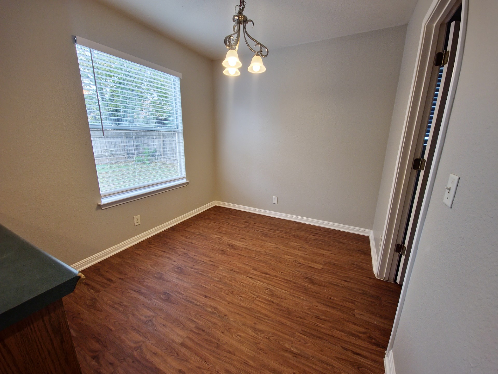 107 Orange Tree Lane Georgetown, TX 78626 - Photo 6 of 16 Laminate flooring and a central window illuminate this flexible interior space.
