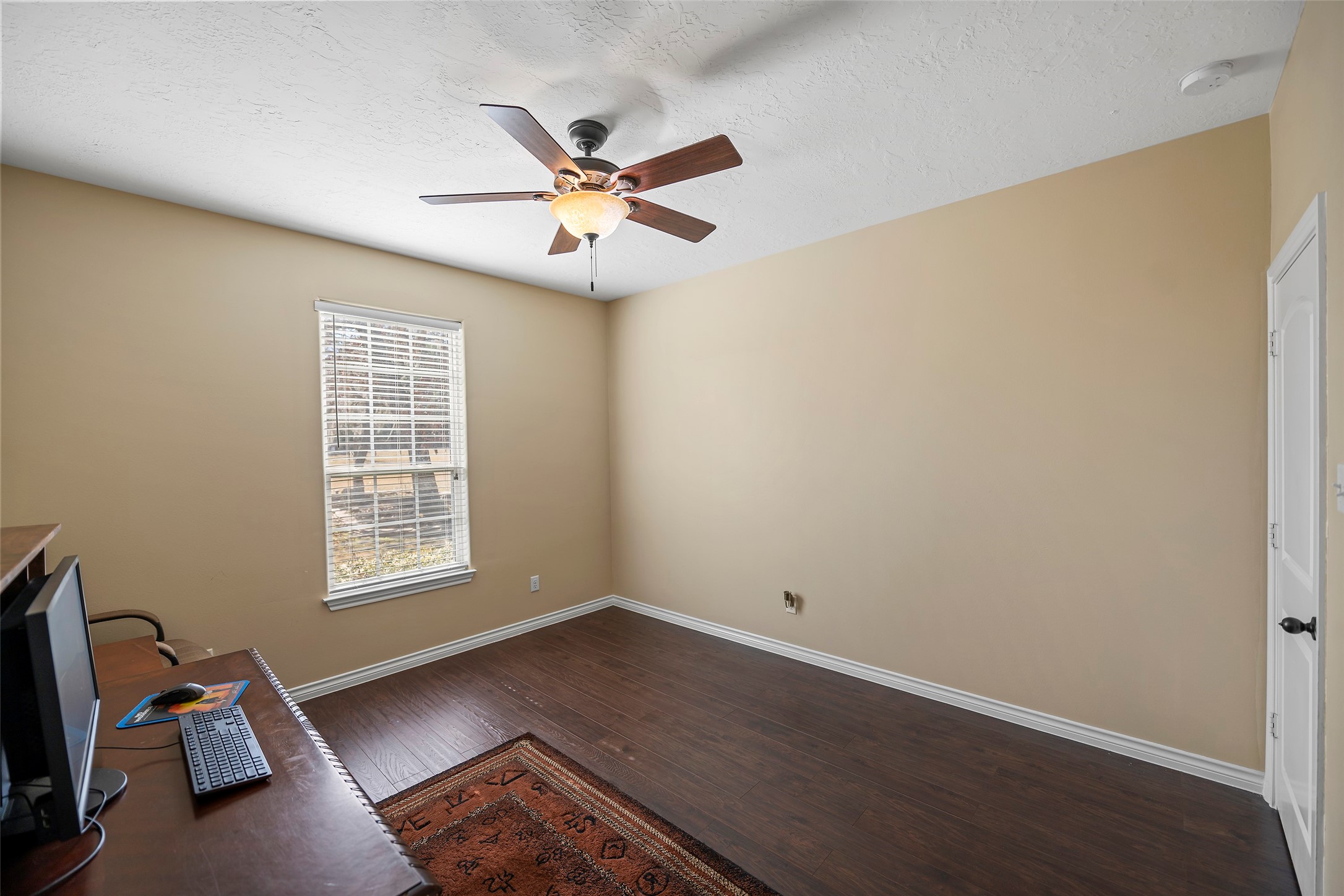 23530 Hargrave Road Hockley, TX 77447 - Photo 8 of 46 a view of an empty room with a window and wooden floor