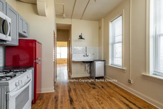 a view of kitchen and utility room with wooden floor