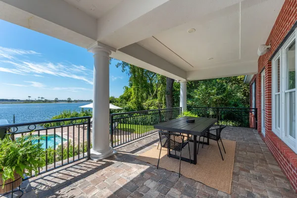 a large kitchen with kitchen island a large counter top space a sink stainless steel appliances and cabinets