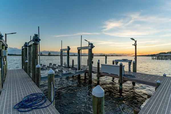 a dining room with furniture a chandelier and wooden floor