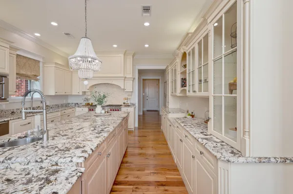 a spacious bathroom with a double vanity sink large mirror and a bathtub