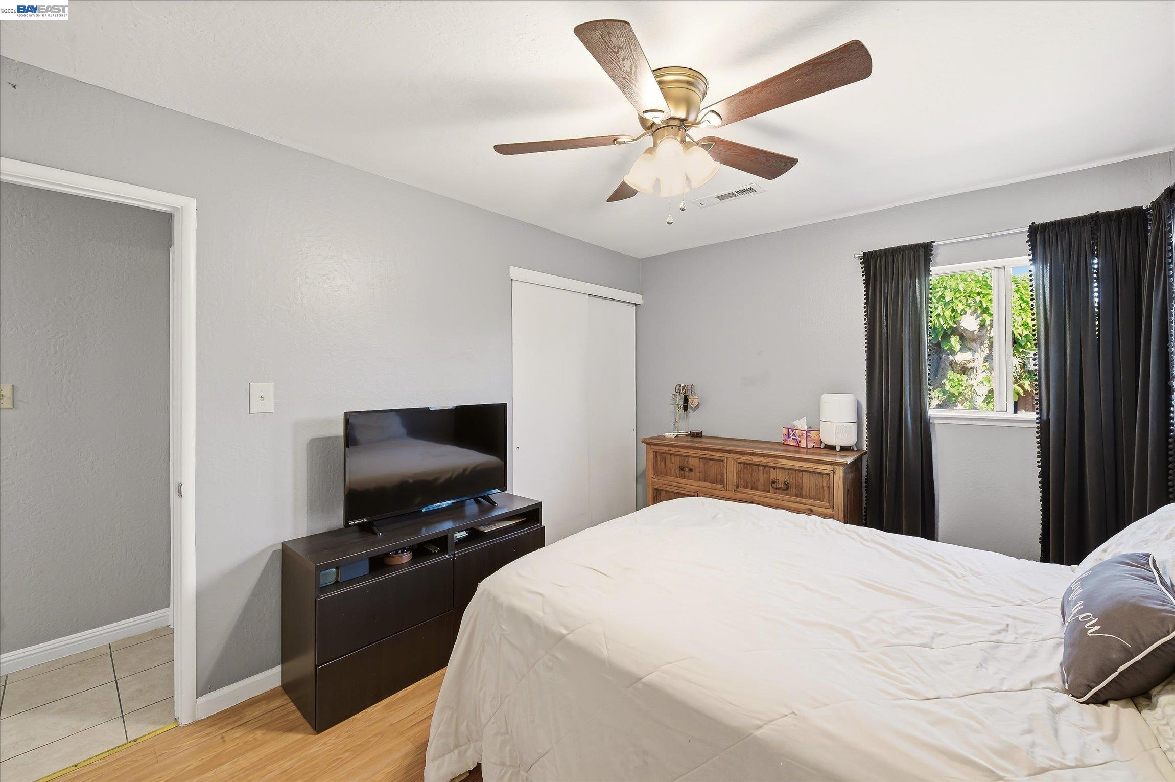 442 James Street Livermore, CA 94551 - Photo 11 of 28 a bedroom with a large bed and a flat tv screen on a dresser