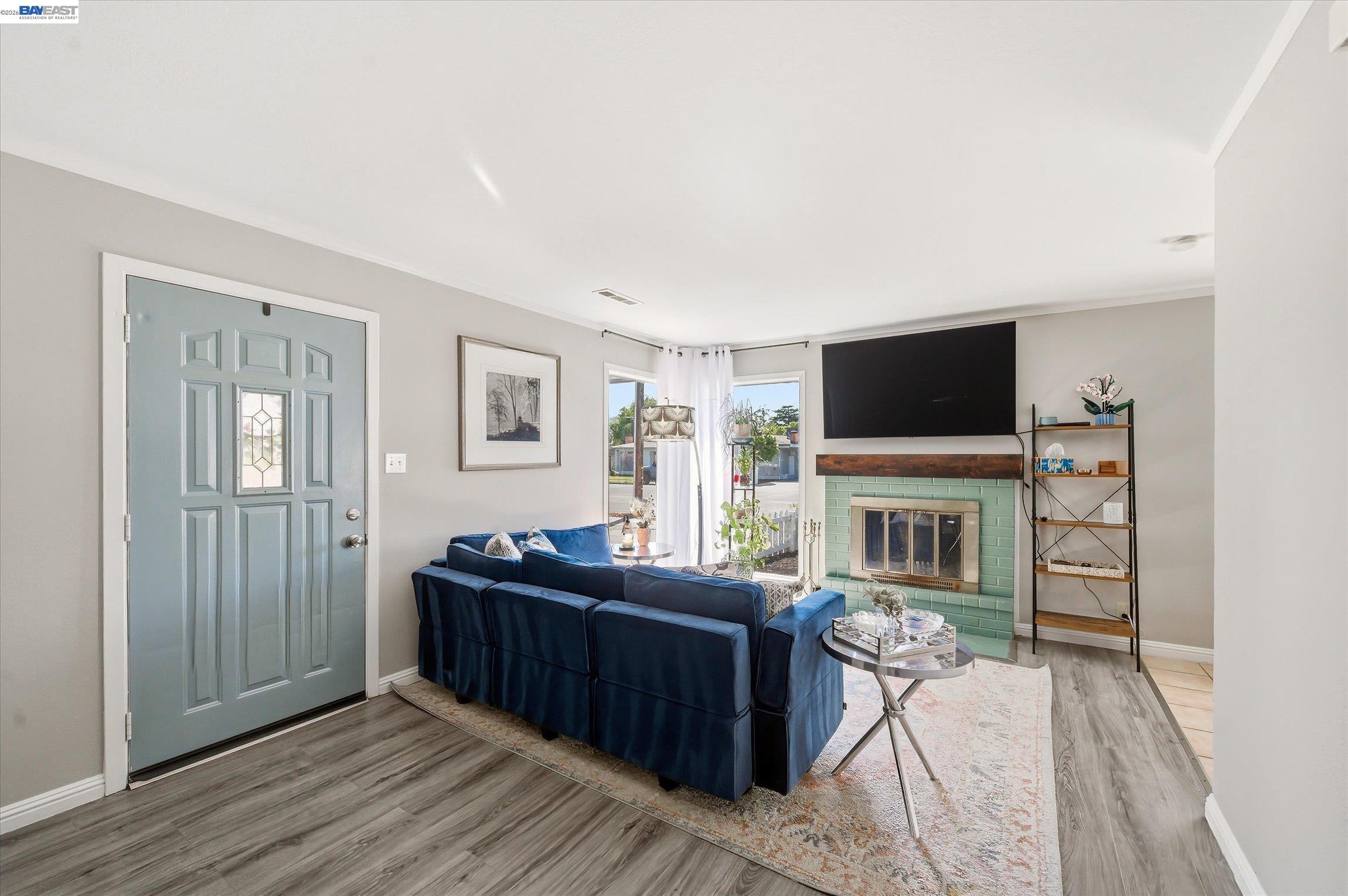442 James Street Livermore, CA 94551 - Photo 2 of 28 a living room with furniture a flat screen tv and a fireplace