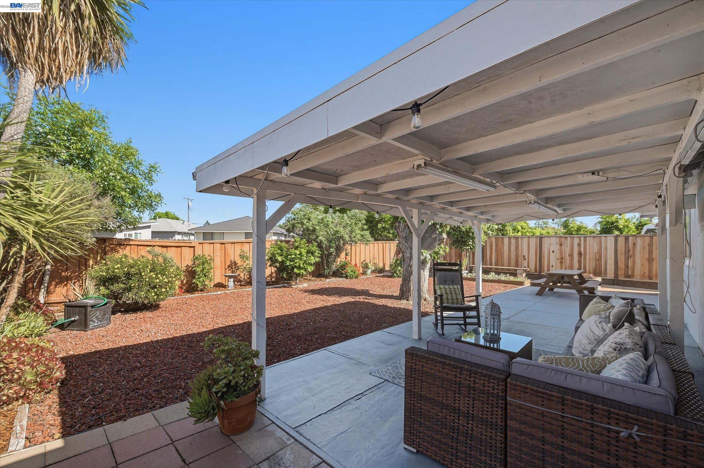 442 James Street Livermore, CA 94551 - Photo 23 of 28 a view of a patio with table and chairs potted plants with wooden floor and fence