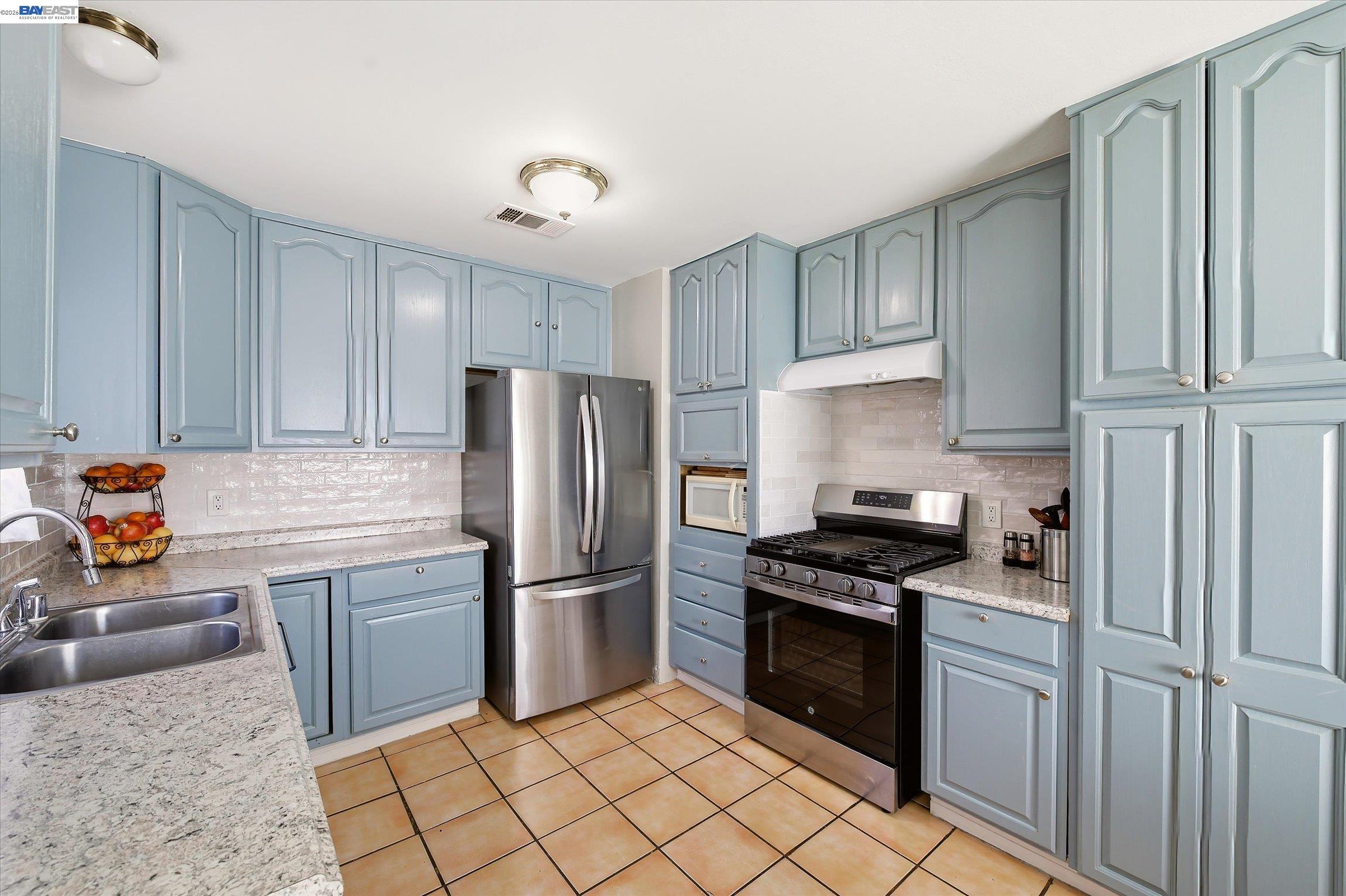 442 James Street Livermore, CA 94551 - Photo 5 of 28 a kitchen with a refrigerator sink and cabinets