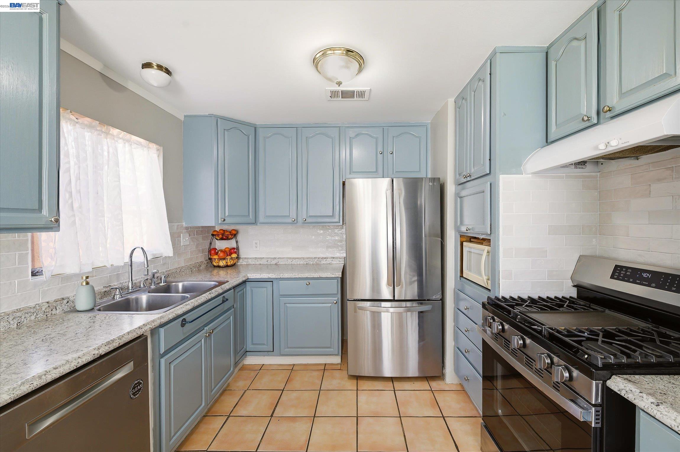 442 James Street Livermore, CA 94551 - Photo 7 of 28 a kitchen with a sink a refrigerator and a stove top oven