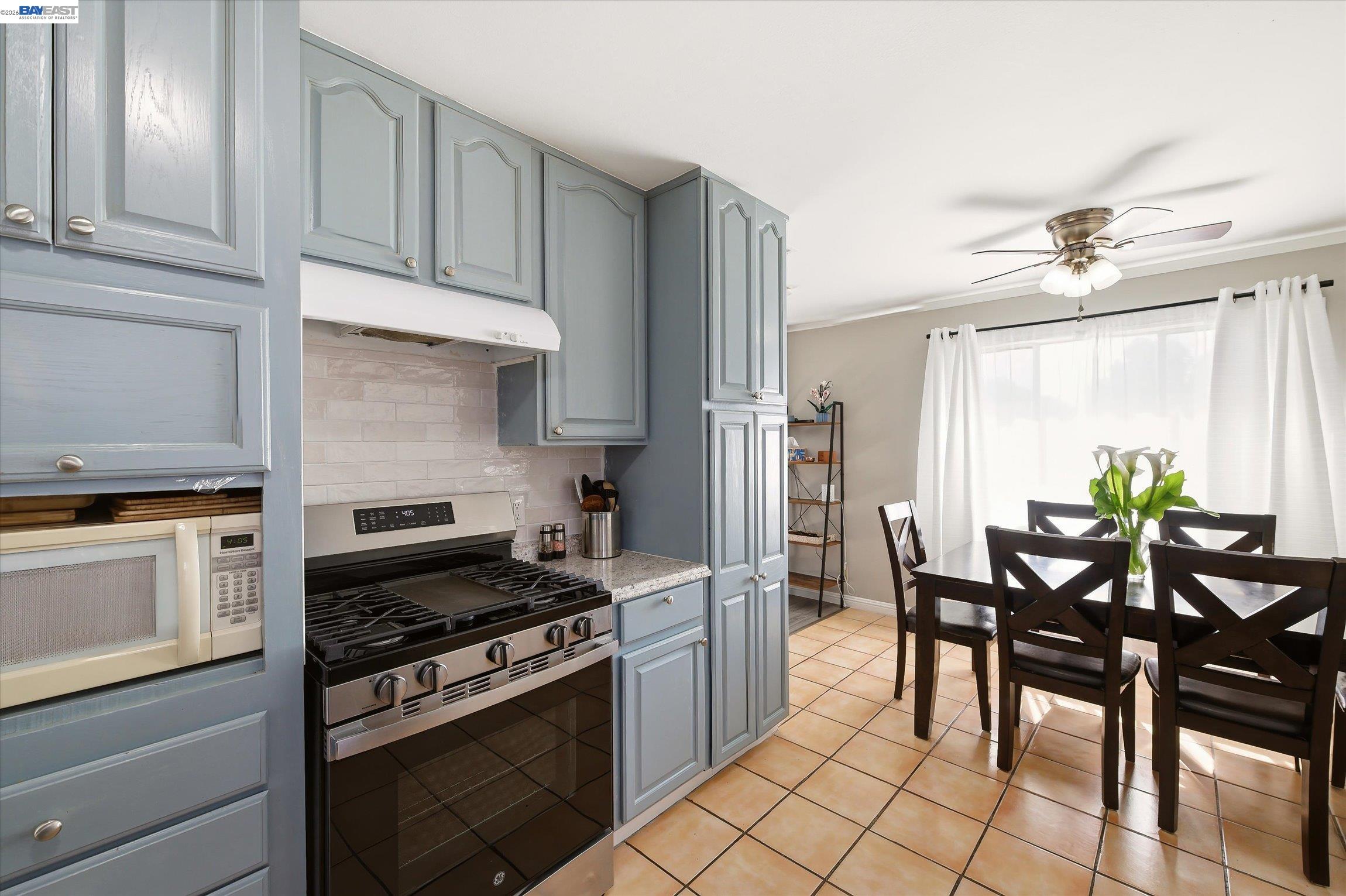 442 James Street Livermore, CA 94551 - Photo 9 of 28 a kitchen with granite countertop a table chairs stove and cabinets