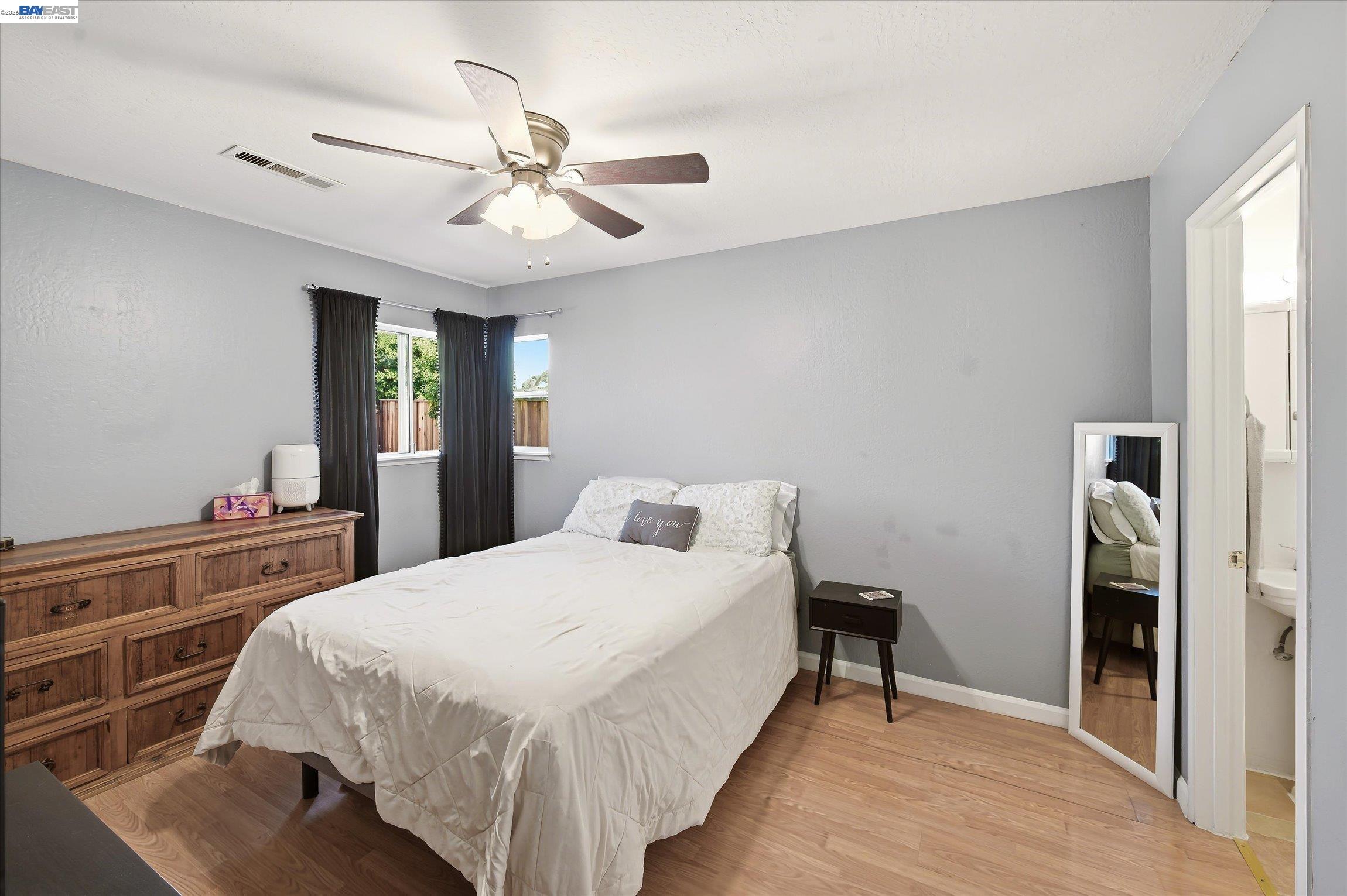 442 James Street Livermore, CA 94551 - Photo 10 of 28 a bedroom with a bed and a chandelier