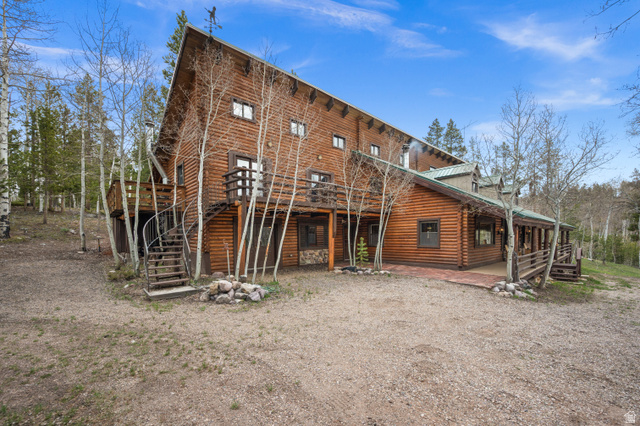 4725 Pine Ridge Road Evanston, UT 82930 - Photo 55 of 82 Log cabin exterior with a multi-level design