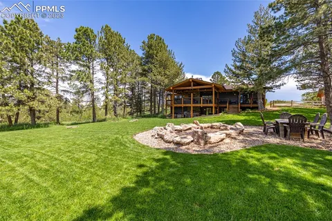 a view of a house with backyard porch and sitting area