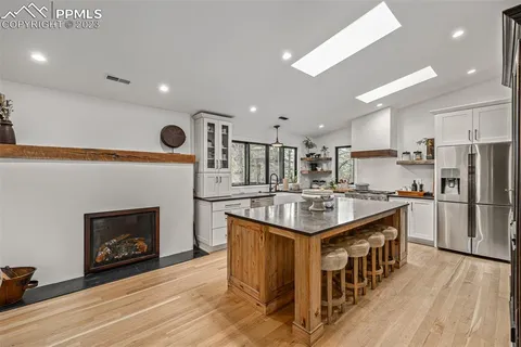 a kitchen with stainless steel appliances granite countertop a stove and a refrigerator