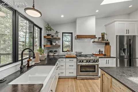 a kitchen with a stove a refrigerator and a sink