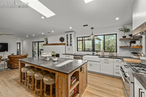 a kitchen with stainless steel appliances granite countertop a stove and a sink