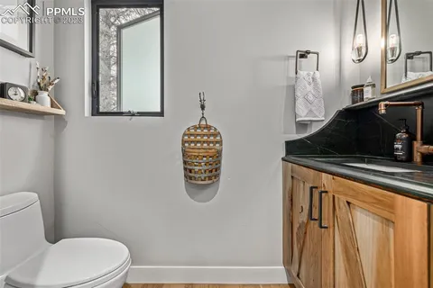 a bathroom with a toilet a sink and mirror