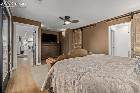 a bedroom with a bed and a chandelier