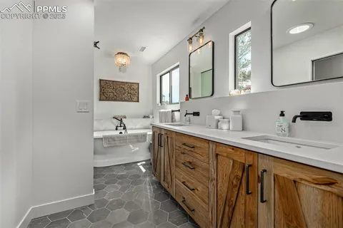 a spacious bathroom with a sink a mirror and a bathtub