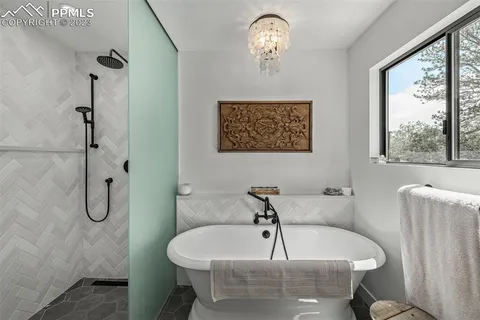 a bathroom with a sink a window and a shower