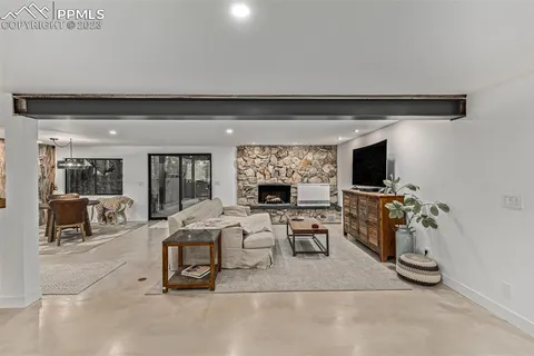 a living room with furniture a flat screen tv and a fireplace