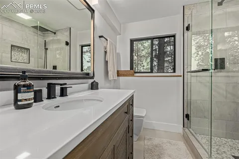 a bathroom with a sink a large mirror and a bathtub