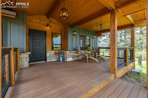 a view of a hall with wooden floor and furniture