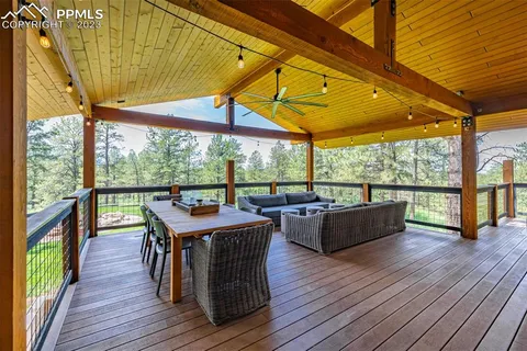 a view of a deck with wooden floor and outdoor seating