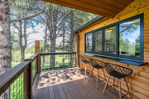 a view of a chairs and table in patio with a backyard