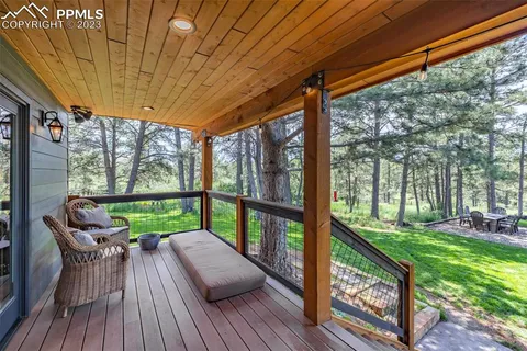 a view of a patio with a table chairs and a backyard