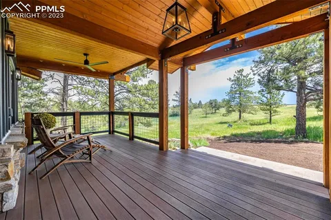 a view of a deck with wooden floor and outdoor seating