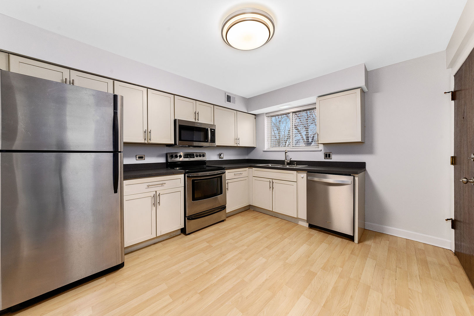 912 South Plum Grove Road, Unit 121 Palatine, IL 60067 - Photo 2 of 11 a kitchen with white cabinets and white appliances