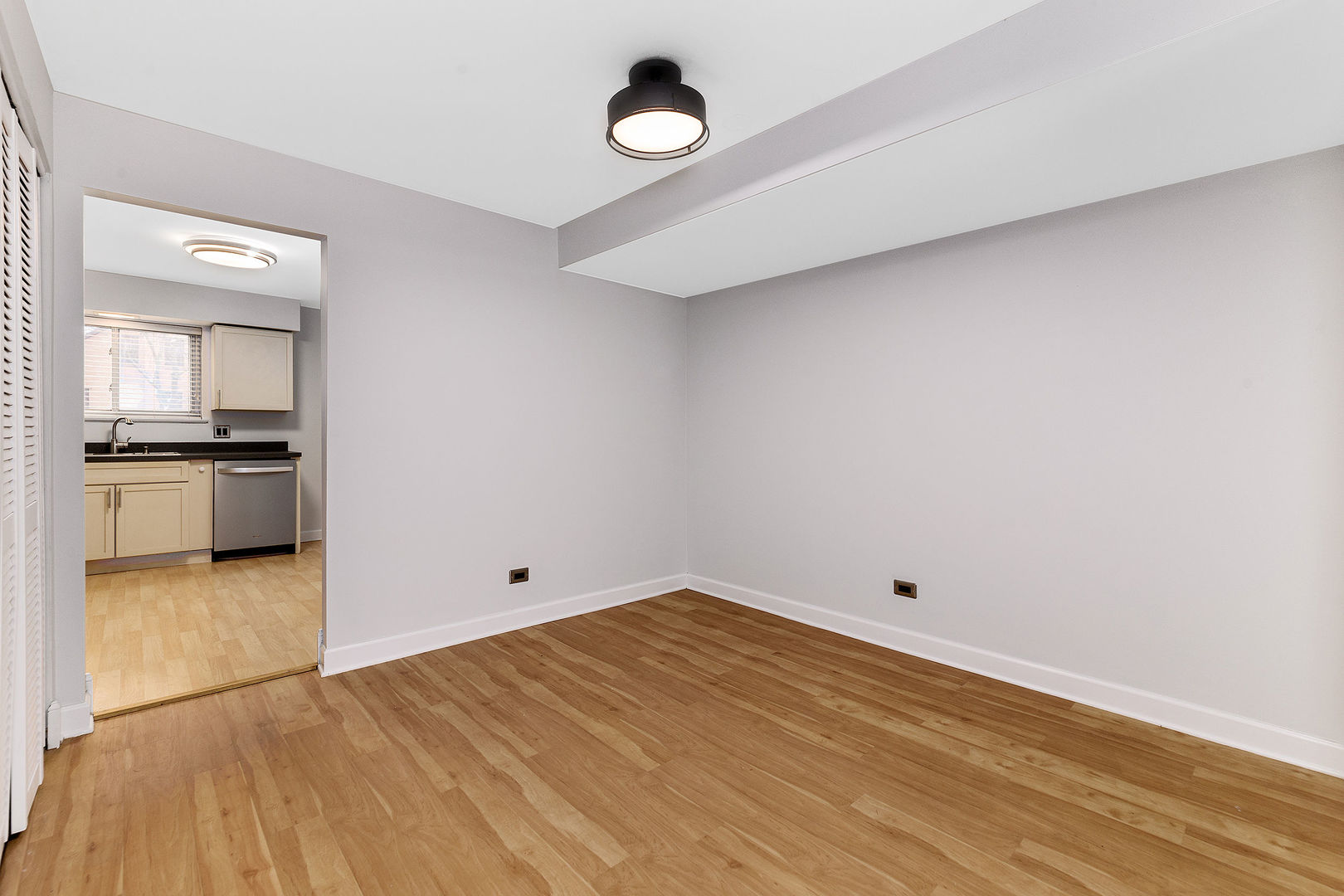912 South Plum Grove Road, Unit 121 Palatine, IL 60067 - Photo 4 of 11 a view of empty room with wooden floor and window
