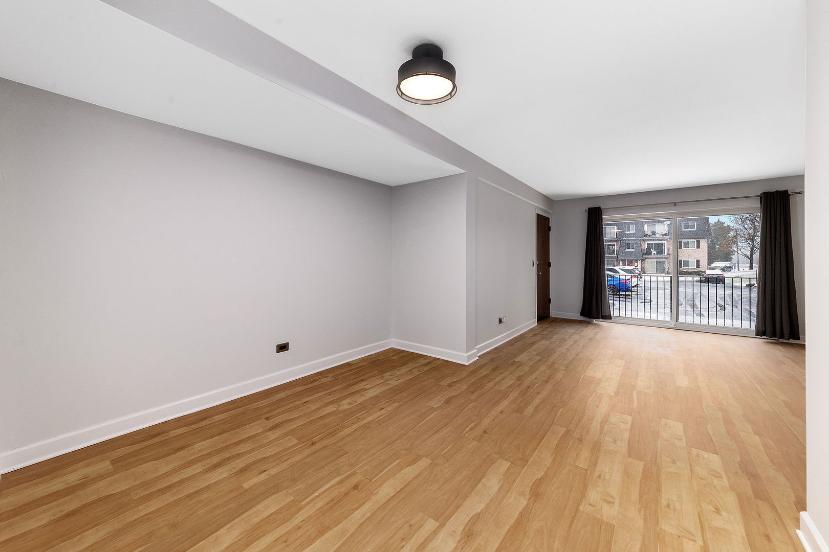 912 South Plum Grove Road, Unit 121 Palatine, IL 60067 - Photo 5 of 11 a view of an empty room with a window and a kitchen