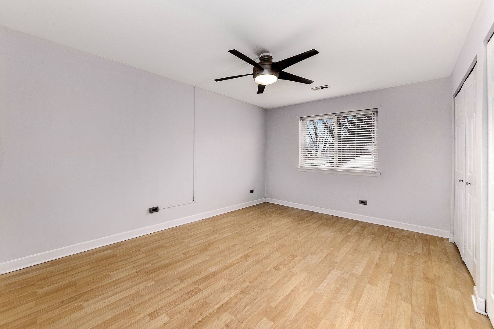 912 South Plum Grove Road, Unit 121 Palatine, IL 60067 - Photo 8 of 11 a view of empty room with wooden floor and fan