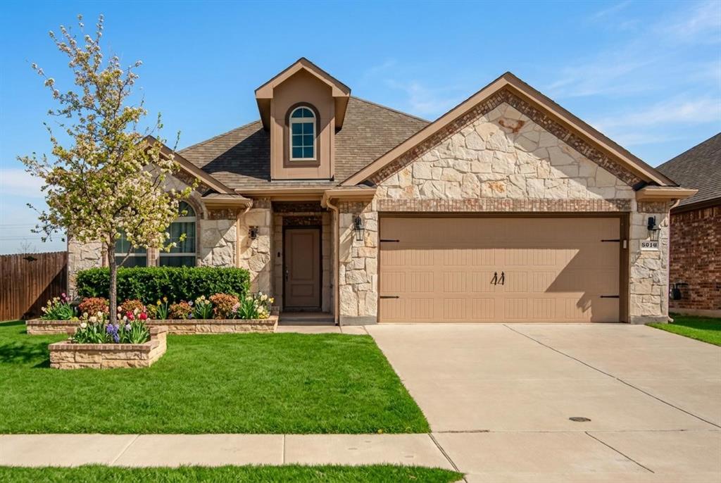 3616 Pinto Way Aubrey, TX 76227 - Photo 1 of 38 a front view of a house with a garden and plants