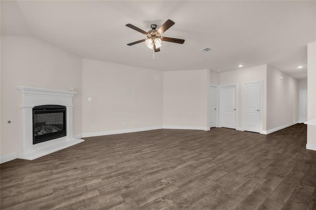 3616 Pinto Way Aubrey, TX 76227 - Photo 12 of 38 a view of an empty room with chandelier fan and fire place
