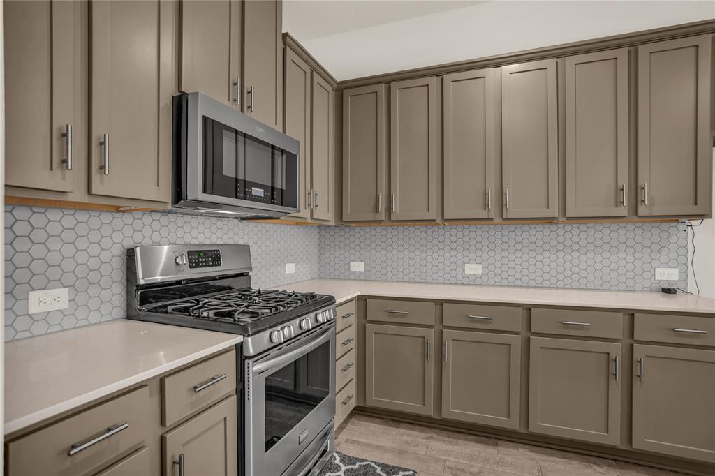 3616 Pinto Way Aubrey, TX 76227 - Photo 17 of 38 a kitchen with cabinets appliances and a sink