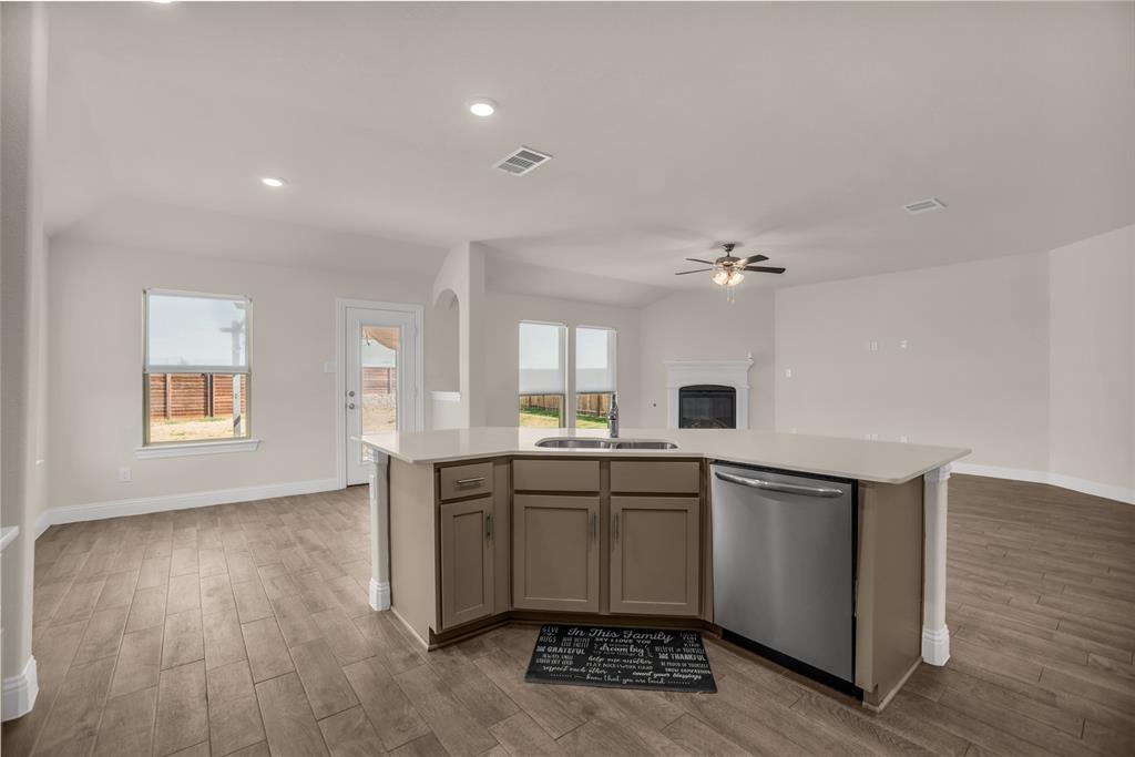 3616 Pinto Way Aubrey, TX 76227 - Photo 18 of 38 a kitchen with granite countertop a sink and cabinets