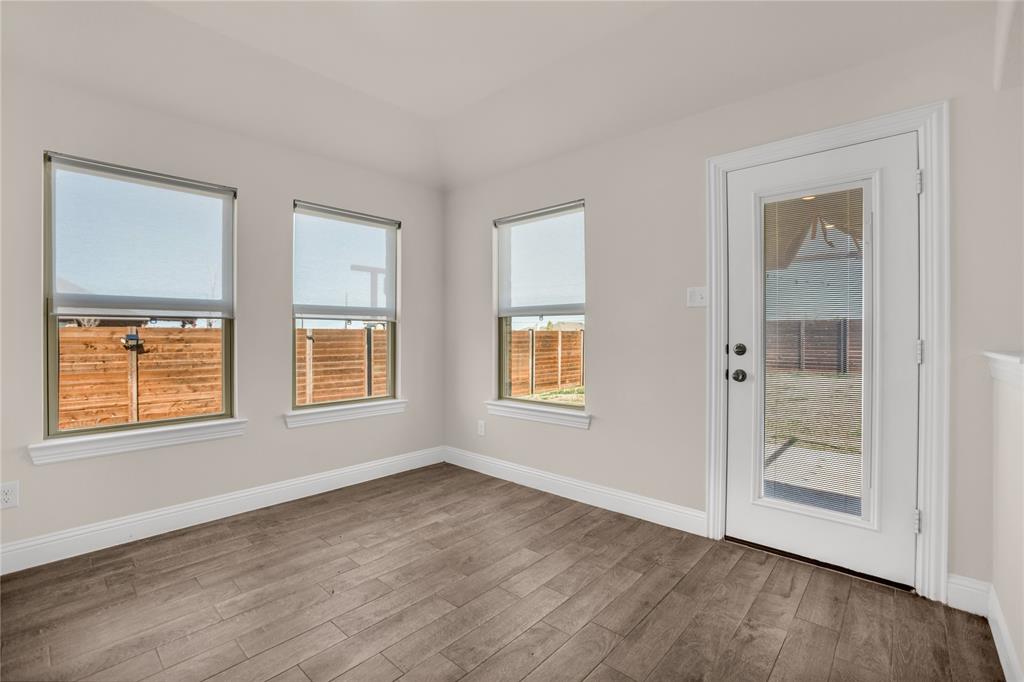 3616 Pinto Way Aubrey, TX 76227 - Photo 19 of 38 an empty room with wooden floor and windows