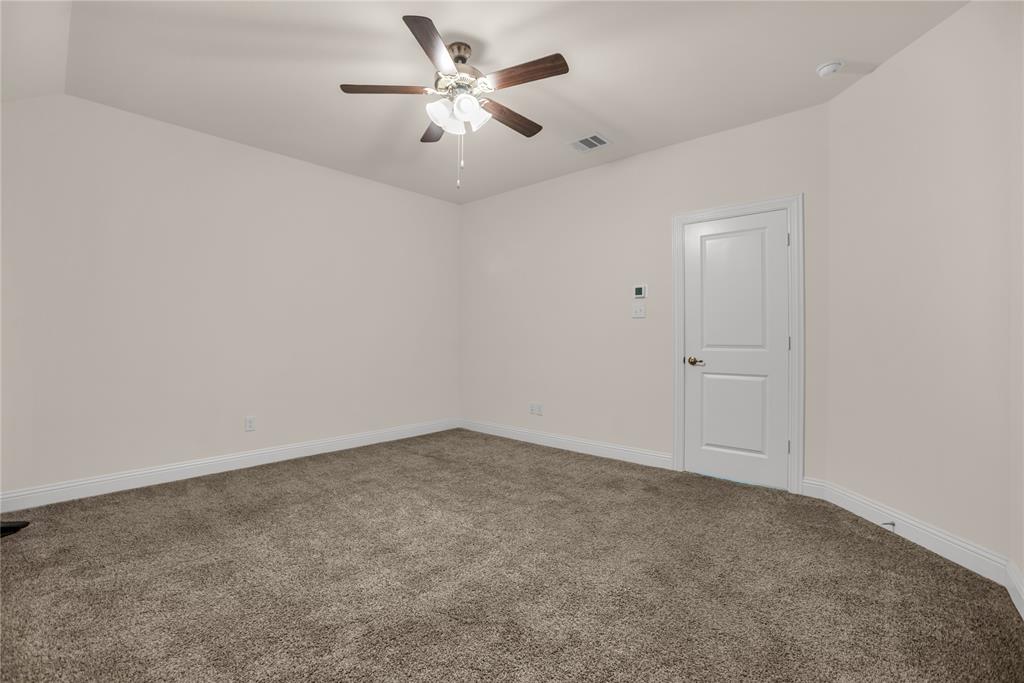 3616 Pinto Way Aubrey, TX 76227 - Photo 23 of 38 an empty room with a chandelier fan and windows