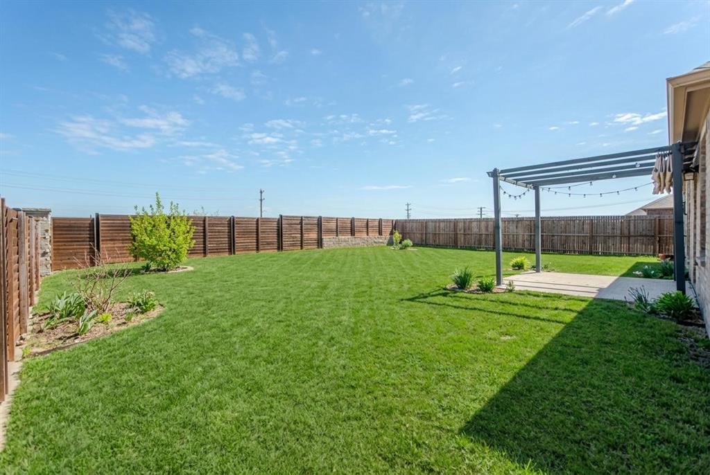3616 Pinto Way Aubrey, TX 76227 - Photo 30 of 38 a view of a house with backyard and a garden
