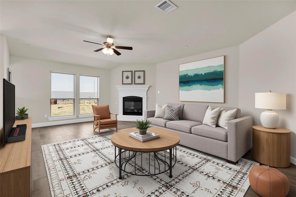 3616 Pinto Way Aubrey, TX 76227 - Photo 4 of 38 a living room with furniture a table and a flat screen tv