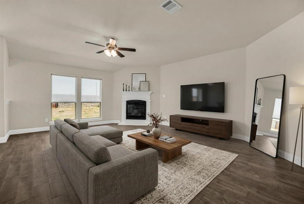 3616 Pinto Way Aubrey, TX 76227 - Photo 5 of 38 a living room with furniture ceiling fan and a flat screen tv