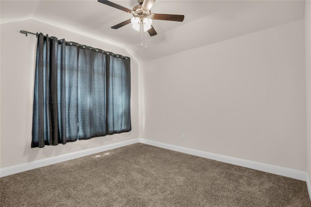 3616 Pinto Way Aubrey, TX 76227 - Photo 9 of 38 an empty room with a ceiling fan and window