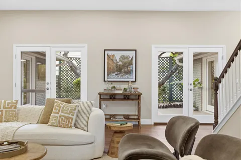 a view of a chairs and table in the back yard of the house