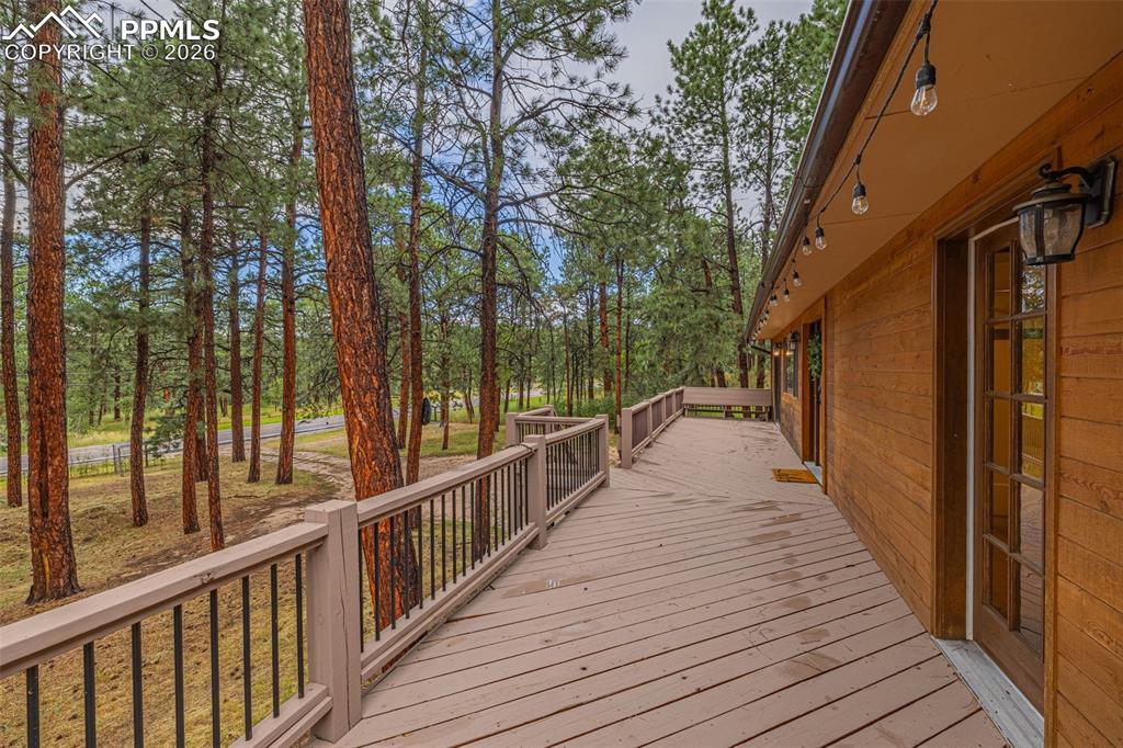 15845 Roller Coaster Road Colorado Springs, CO 80921 - Photo 21 of 29 a view of balcony with wooden floor and fence